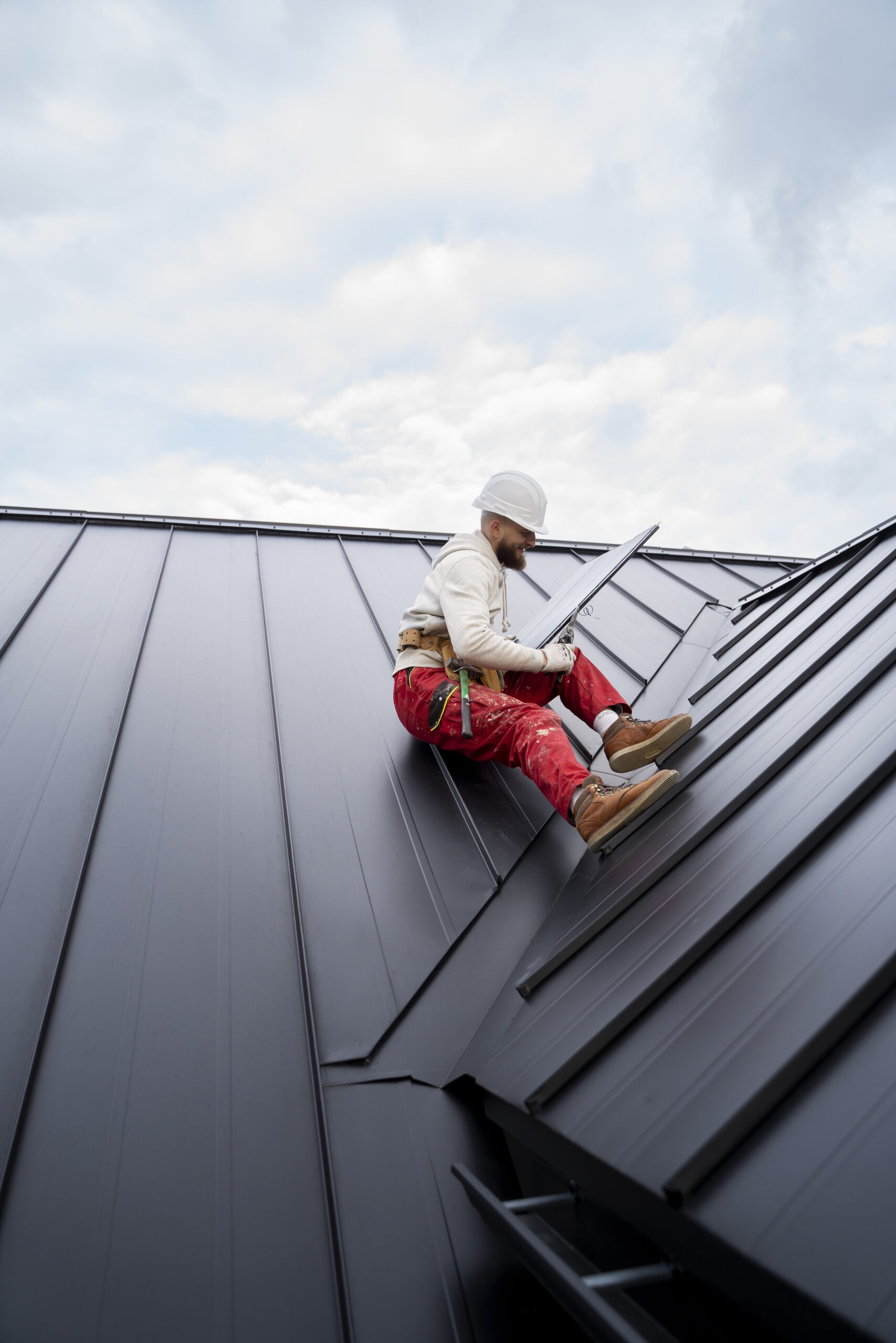 full-shot-man-with-helmet-sitting-roof